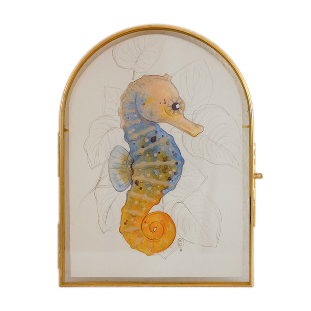 Illustration of a blue and orange seahorse with graphite leaves in the background. 