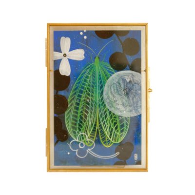 Drawing of a lacewing bug, green with yellowish wings. Background is dark blue with black and white flowers, making piece into a collage aesthetic.
