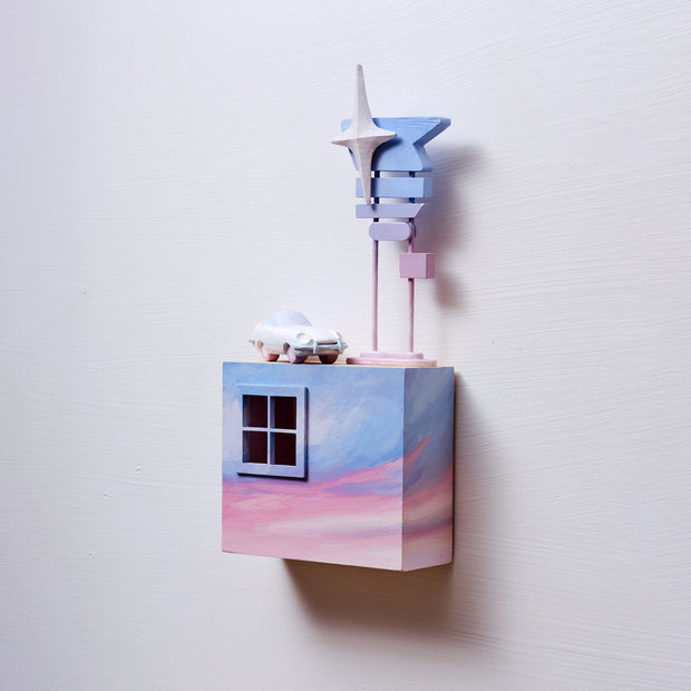 Small square wood panel painted like a pinkish purple sunset, with a sculpted window in the upper left. Atop of it are carved wooden sculptures: a retro style light blue car and a signpost with 5 different signs attached, no words, all a bluish purple sunset with one large sparkle.