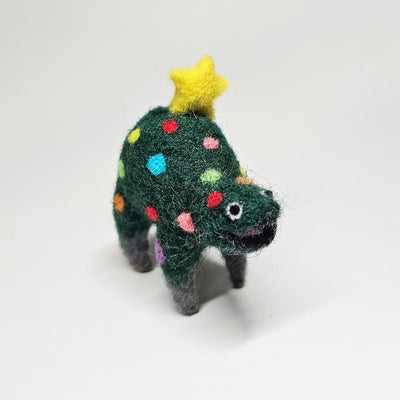 Needle felted wool sculpture of a dark green rounded body quadruped creature with an open mouth smile and small black eyes. Its body has colorful polkadots, like lights on a Christmas tree and a felted yellow star on top.