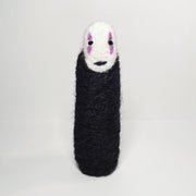 Needle felt wool sculpture of No Face from Spirited Away, standing without any visible limbs (arms or legs).