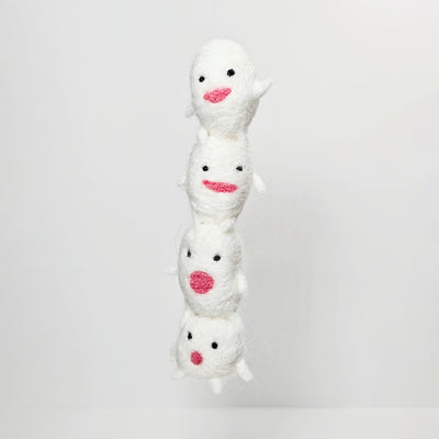 Needle felted sculpture of a stack of 4 cute, simplistic white blob characters with tiny limbs and pink mouthed smiles. They stand in various poses.