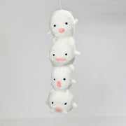 Needle felted sculpture of a stack of 4 cute, simplistic white blob characters with tiny limbs and pink mouthed smiles. They stand in various poses.