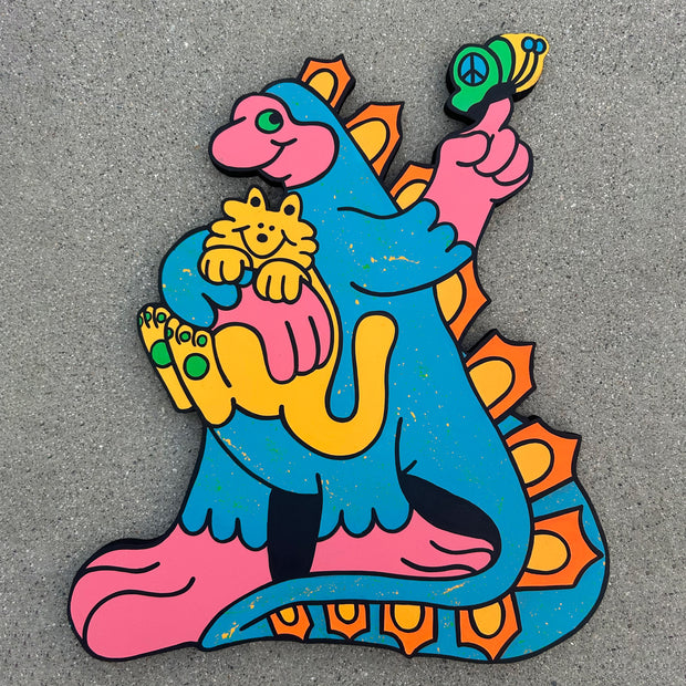 Die cut flat wooden sculpture in the shape of a dinosaur, with a long tail and large feet. It stands and holds a fluffy yellow cat and a butterfly lands on its other hands. Color are bright pinks, yellows and blues.