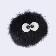 Fluffy ball of black fabric with 2 small eyes, very close together. Plush has a safety pin backing .