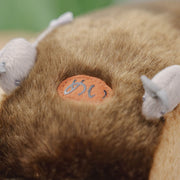 Fluffy large plush of Catbus, laying on its stomach with attached elements such as mice as tail lights and 3D eyes, nose, whiskers.