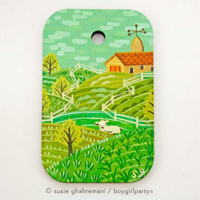 Painting of a small white lamb resting in a setting of rolling farmed hills with a orange barn in the background. Sky is blue green.