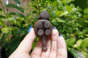 Underside of ceramic sculpture of a four legged small creature. 