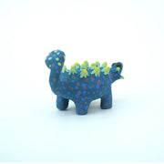 Sculpture of a blue stylized Ankylosaurus with neon green spikes and blue and purple polka dots on its body. It has a long tail and large shiny eyes.