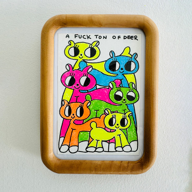 Framed drawing of many colorful cartoon deer with simple, large eyes and text at the top that reads "A fuck ton of deer""