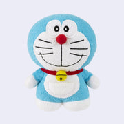 Small plush doll of Doraemon, a blue cat with large anime eyes and smile and no ears. He has a red collar with a bell on it and a small pocket on its stomach.