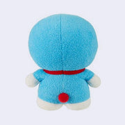 Small plush doll of Doraemon, a blue cat with large anime eyes and smile and no ears. He has a red collar with a bell on it and a small pocket on its stomach. Back view.