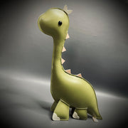 Pleather plush sculpture with a mostly flat body of a green dinosaur with a long neck, a big cartoonish head and small spikes along its back.