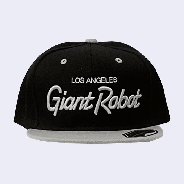 Flat billed black cap with a gray bill and gray stylized letters that say "Los Angeles Giant Robot" across the front.