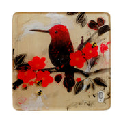 Illustration of a black and red hummingbird sitting on a branch with red flower blossoms and black leaves. A small silhouetted woman sits on the branch and looks onwards.