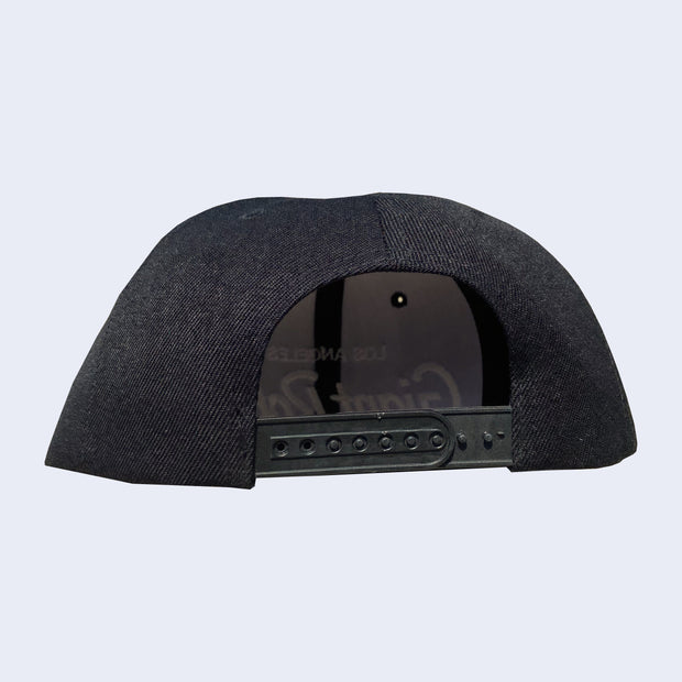 Back of black cap with snap adjustable closure.