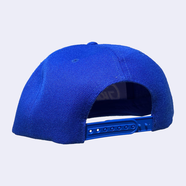 Back view of blue cap with adjustable strap closure.