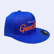 Flat billed cap, bright blue with white and orange stylized letters that say "Los Angeles Giant Robot" across the front.