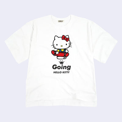 Oversized white t-shirt with a graphic of Hello Kitty standing and holding a skateboard. Below her is a black crown and text that reads "Going Hello Kitty."