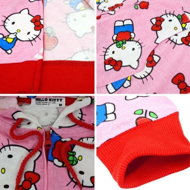 Pink hooded zip up jacket with a repeating all over pattern of Hello Kitty, standing and sitting with flowers and apples. "Hello Kitty" is written in white font throughout the pattern. Close up