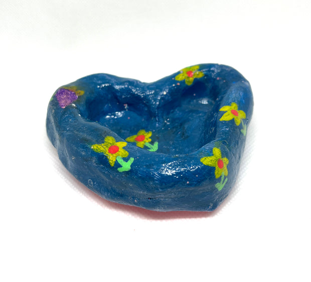 Lumpy blue heart shaped dish with painted on yellow flowers.