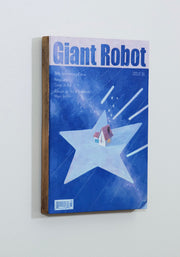 Painting of a mock Giant Robot Magazine cover, featuring a cover illustration of a house flying through the night sky atop of a very large light blue star. Fake text lines the sides.