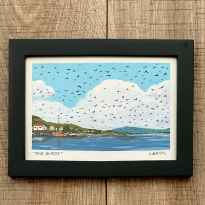 Framed painting of a sea side scene with a small town on the coast, large fluffy white clouds and many birds flying in the sky.