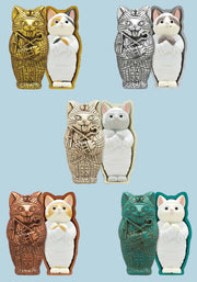 Series of 5 figures of sarcophagus shaped like a cats with a different colorways of mummified cats inside. 