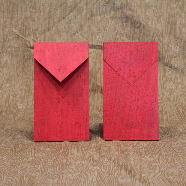 Back view of 2 red envelopes made out of wood. They have flaps that open and close and a thin slot for a sheet of paper or money to go into.