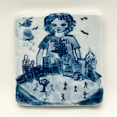 Blue drawing on a white ceramic tile of a girl wearing a t-shirt that reads "Destroy!" and standing over a much smaller city that is up in flames with small stick figures running around it.