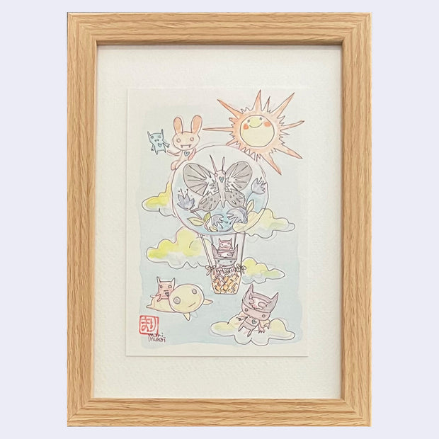 Framed illustration of a hot air balloon with a small blue character in the basket. Balloon has a butterfly and botanicals design. Other characters fly in the sky close by.