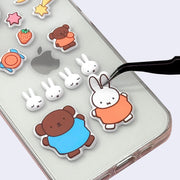 Example of puffy Miffy themed stickers being placed onto the back of a cell phone case.