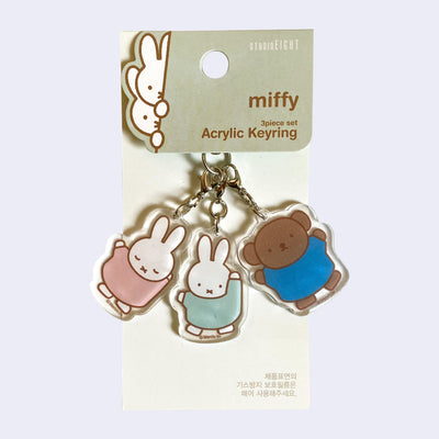 3 Acrylic charms making up a single keychain, each of Miffy characters - Miffy with her eyes closed dressed in muted pink, Miffy with her eyes open dressed in mint and Boris dressed in blue.