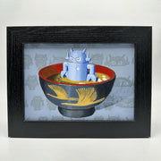 Painting of a blue robot doll in a bowl of miso soup. Interior of the bowl is red and exterior is black with gold cranes. Piece is framed.