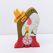 Die cut painted wooden sculpture of a green frog with a cowboy hat and red boots holding a guitar.