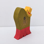 Die cut painted wooden sculpture of a green frog with a cowboy hat and red boots holding a guitar. Back view with signature.