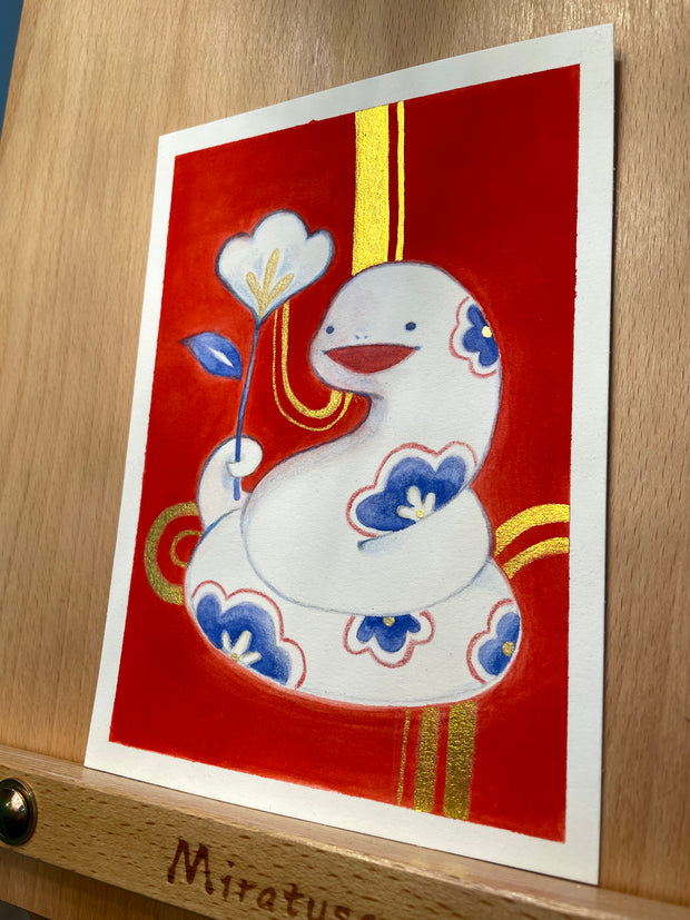 Painting on bright red background of a white, cute cartoon style snake with small dot eyes, floral patterning, and a happy open mouth. It is coiled into itself and holds a single white and blue flower in its tail. Gold curved striped are in the background.