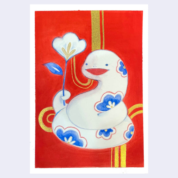 Painting on bright red background of a white, cute cartoon style snake with small dot eyes, floral patterning, and a happy open mouth. It is coiled into itself and holds a single white and blue flower in its tail. Gold curved striped are in the background.