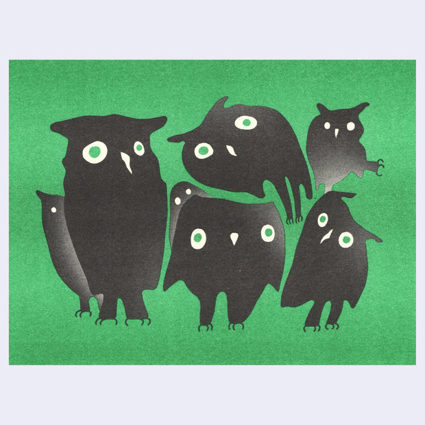 Risograph print of 7 owls, shaped in various ways to show differing angles and stylistic choices. They are all fully black or gray and have green wonky eyes. Background is green.