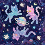 Cut paper artwork of 3 purple, pink and blue mixed colored cats floating around a colorful planet with 2 rings. They all hover amongst many stars on a dark purple background.