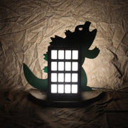 A “high rise” with Godzilla behind it. Light up elements are in the building and on Godzilla’s back.