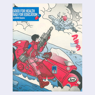 Cover of a fanzine dedicated to Akira, with a 3 color printed illustration of a boy dressed in red riding a futuristic looking motorcycle and holding up a heavy duty gun. He holds it up towards a far off character, who stands atop of rocks.