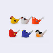 Group of 6 different plastic bird shaped whistles, colors vary.