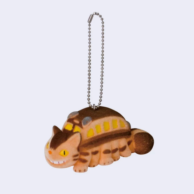 Flocked keychain of a smiling orange and brown cat shaped like a bus from My Neighbor Totoro, hanging from a keychain.