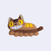 Small plush doll of Catbus from My Neighbor Totoro, with a long skinny body and a wide smile. 