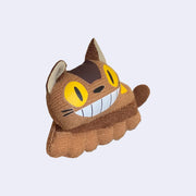 Small plush doll of Catbus from My Neighbor Totoro, with a long skinny body and a wide smile. 