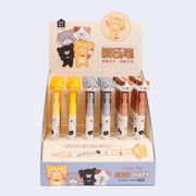 Pens with a twisting mechanism to reveal to pen tip with rubber cat heads as pen toppers. The cats have cute cartoon expressions and are 3 different colorways: gray, orange and calico. In their display box.