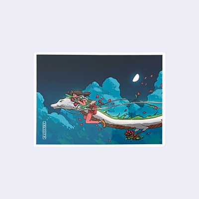 Rectangular shaped sticker of an illustration from Spirited Away of a little girl, Chihiro, riding atop of a white thin dragon through the dark night sky with flower petals flying behind them.