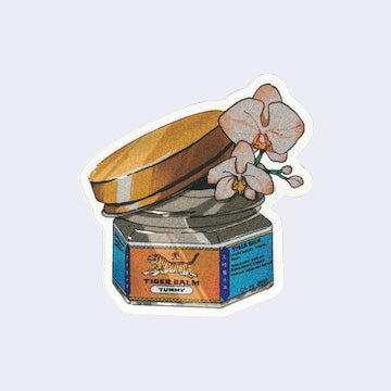 Die cut sticker of a short glass jar of Tiger Balm with a golden lid. The lid is slightly ajar and 2 orchids and buds peep out of the jar.