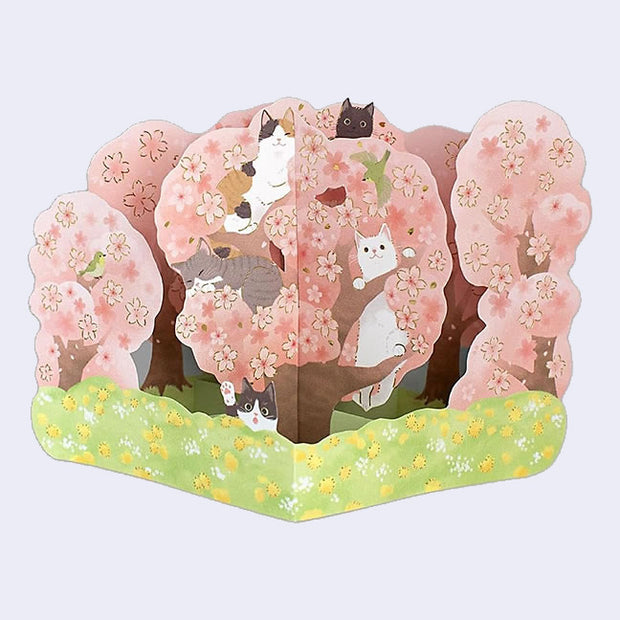 3D card of a cherry blossom tree on green grass with many cute, different colored cats popping out from various branches and flower blossoms.